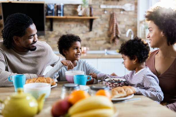 istock Happy black family talking while having breakfast in the morning. 1188236080