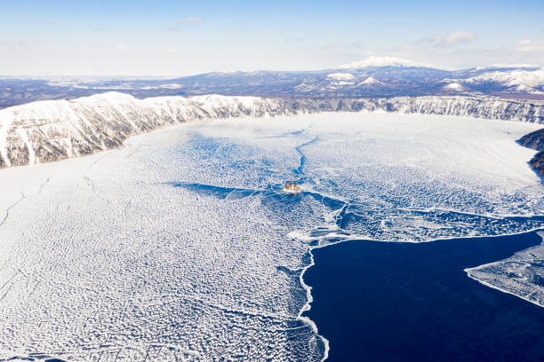 Aerial winter view of the Frozen Japanese Lake Mashu Aerial view of the frozen Lake Mashu
(Has volcano crater)during the winter , Hokkaido, Japan national park akan stock pictures, royalty-free photos & images