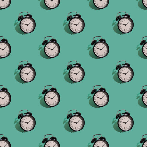 istock Many black classic style alarm clock isolated on green background 1188237416