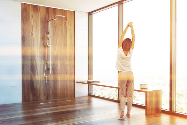 istock Woman in white bathroom with shower 1188237419