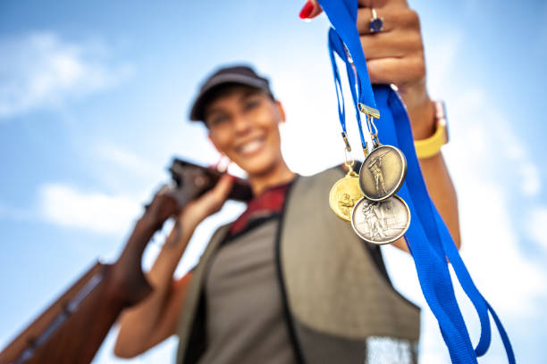 adult woman holding skeet shooting sport medals - silver medal 2nd medal second place imagens e fotografias de stock