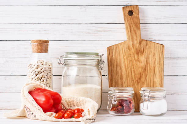 istock Kitchen utensils background with cutting board and reusable glass  containers with a food ingredients. Zero waste concept 1188238007