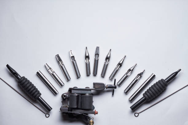 a tattoo artist shows off his tattoo machine