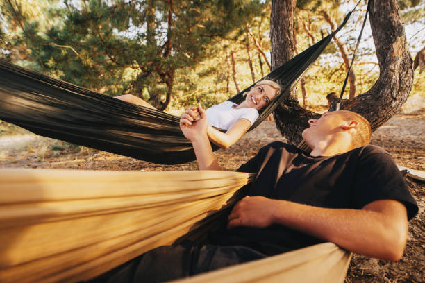 istock Romantic couple relaxing in hammock in the forest 1188239463