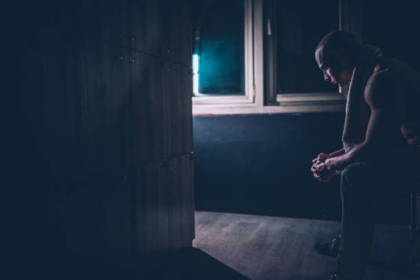 istock Bodybuilder sitting at dark locker room 1188239870