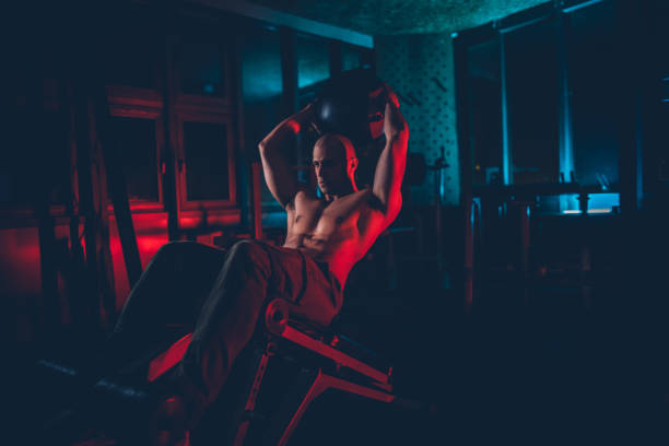 istock Bodybuilder doing sit ups with medicine ball at the gym 1188240013