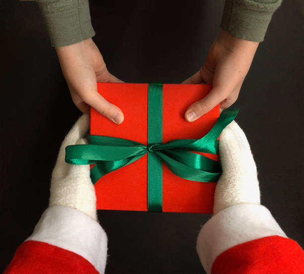 istock Santa giving a Xmas present to a kid 1188240103