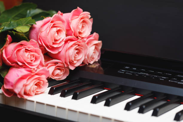 istock pink roses bouquet on electric piano keys 1188241076