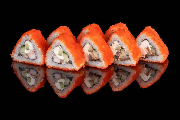 Photo of Japanese food. Sushi and beaters on a black background. Close up.