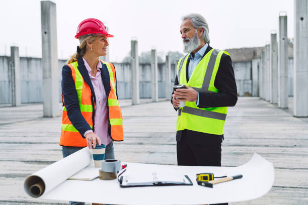 istock Woman architect and senior engineer working together on construction site 1188241917