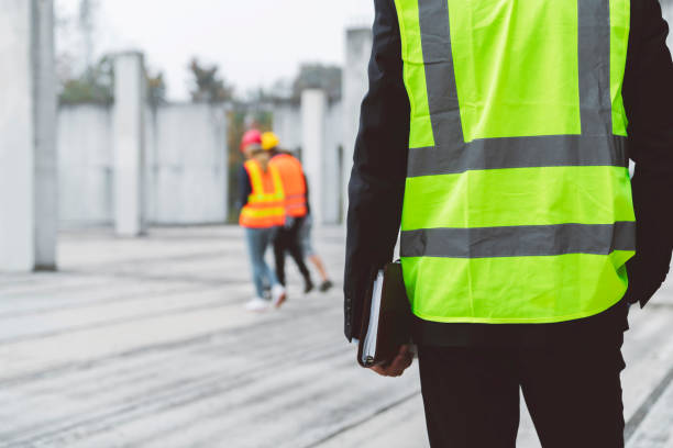 istock Silhouette of a man in reflective vest head down on construction site 1188241919