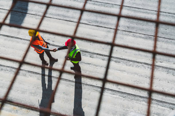 istock Aerial view of two diverse man shaking hands on construction site 1188241957
