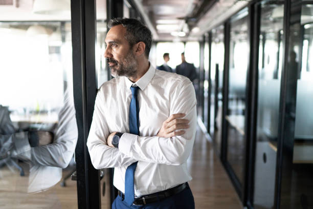 istock Businessman looking away at corridor office 1188243636