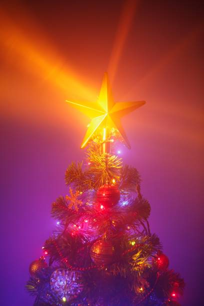 istock Christmas tree with festive lights, purple background 1188244568