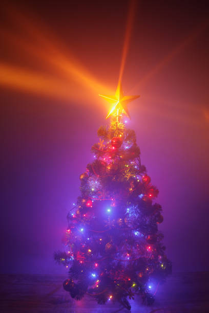 istock Christmas tree with festive lights, purple background 1188244629