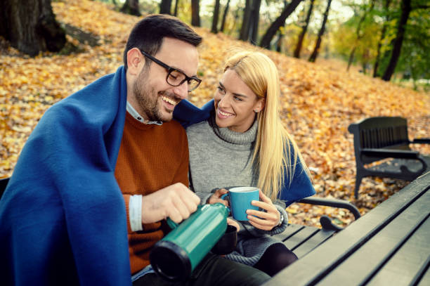 istock Happy couple drinking tea in park 1188244782