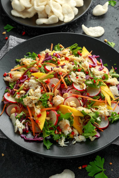 istock Crab salad with vegetables, radish, carrots, mango, pine nuts and prawn crackers 1188245093