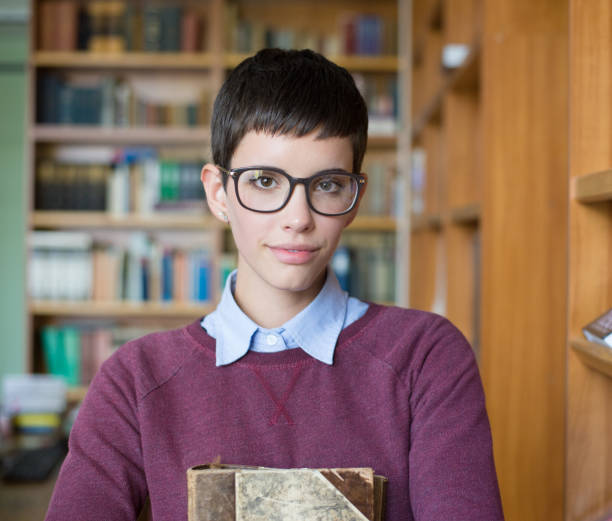istock Young woman studying in the library 1188245814