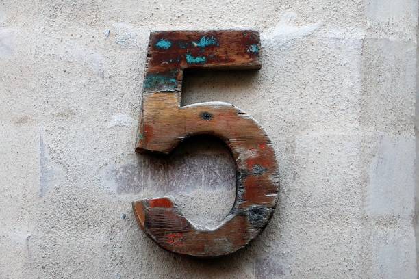 close up of a wooden house number