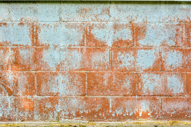 istock Texture of red fluted brick wall with white peeling paint 1188246053