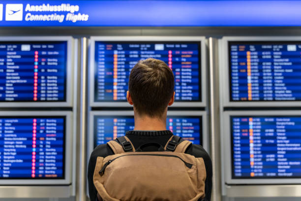 istock young man checking the timetable at the airport 1188246246