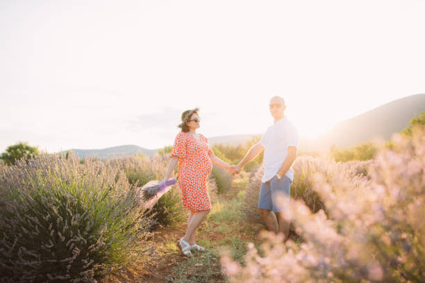 istock Couple expecting baby in lavender field 1188251574