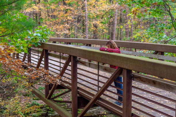 istock woman standing on bridge looking over railing 1188251722
