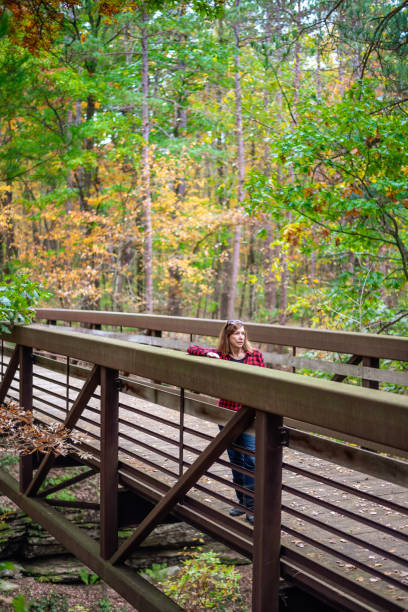 istock woman standing on bridge while hiking outdoors in Wisconsin Dells 1188251728