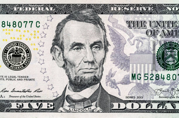 Close-up portrait of Abraham Lincoln on a 5 US dollars banknote. stock photo