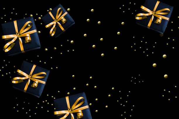 istock Black gift boxes with red ribbon on wooden background. Flat lay 1188256287