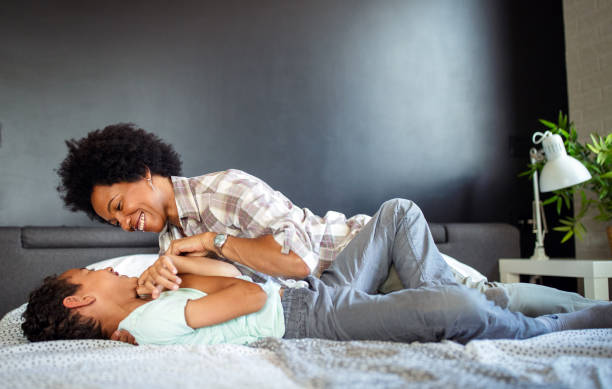 istock Happy mother playing, having fun, hugging with her son at home 1188257703