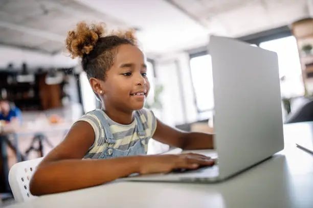 Photo of Girl spending time with notebook and modern technology