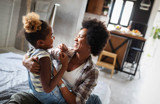 istock Happy mother playing, having fun, hugging with her daughter at home 1188258033
