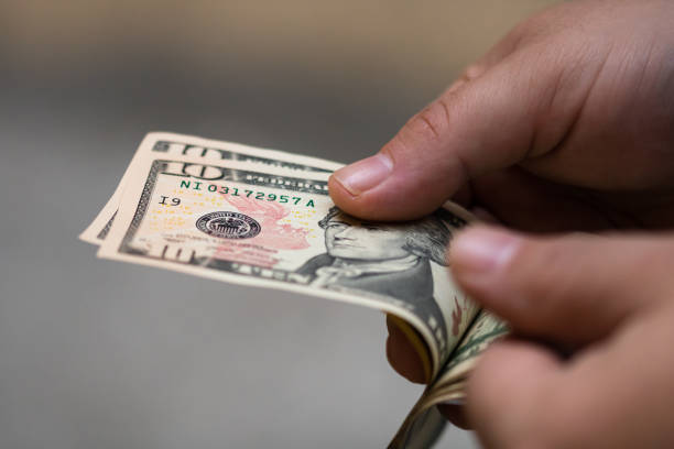 istock Man hands counting money, counting US dollars currency, close up 1188258810