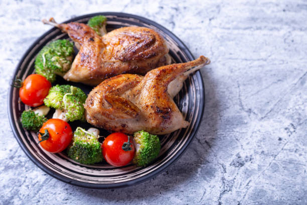 istock Quail, roasted whole, with broccoli and cherry tomatoes 1188259663