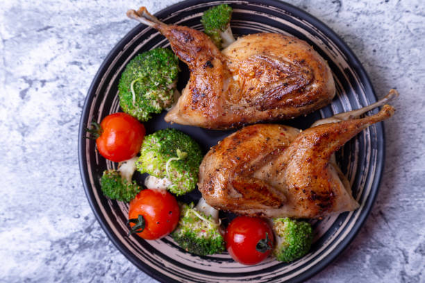 istock Quail, roasted whole, with broccoli and cherry tomatoes 1188259674