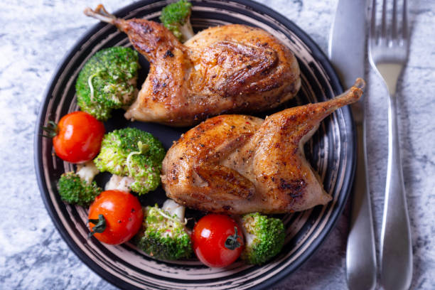 istock Quail, roasted whole, with broccoli and cherry tomatoes 1188260225