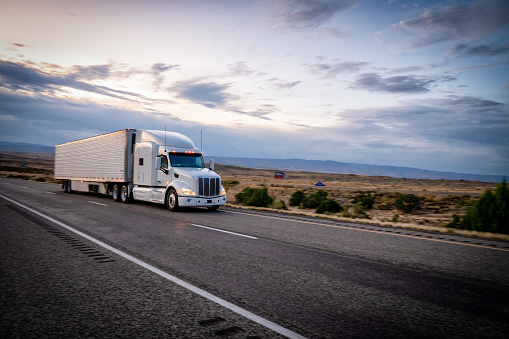 Big freight trucks on the open highway heading to their destinations to make the deliveries