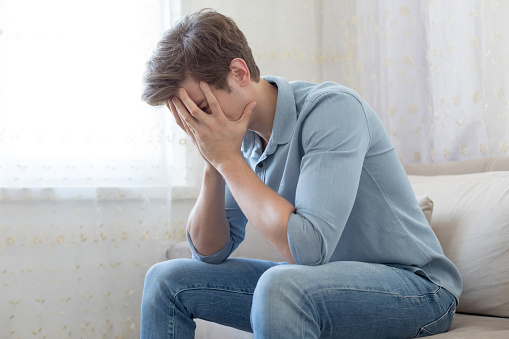 Unhappy man on sofa