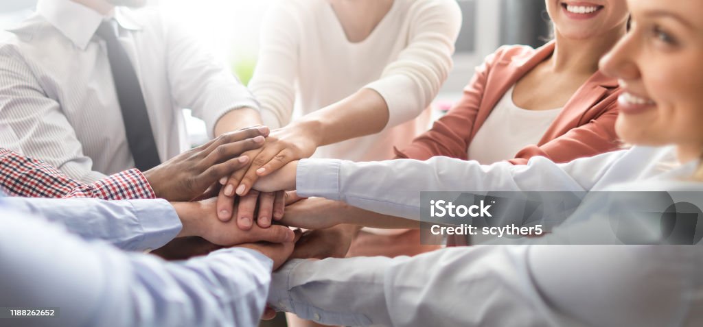 Stack of hands. Unity and teamwork concept. Close up view of young business people putting their hands together. Stack of hands. Unity and teamwork concept. Teamwork Stock Photo