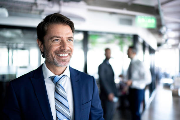 istock Connfident businessman looking away at corridor office 1188262817