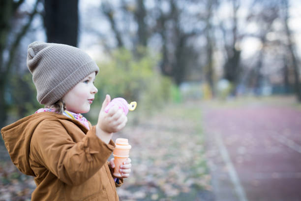 istock Preschool Age Girl Blows Bubbles 1188263222