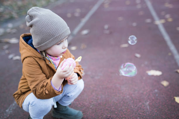 istock Preschool Age Girl Blows Bubbles 1188263241