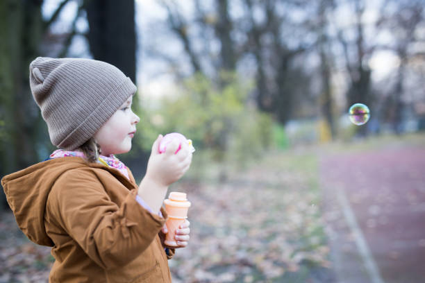istock Preschool Age Girl Blows Bubbles 1188263242