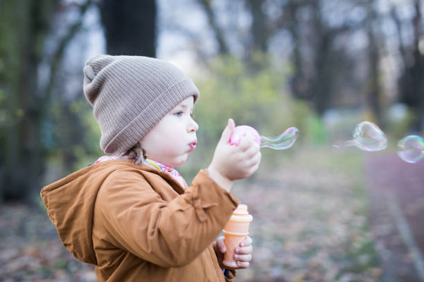 istock Preschool Age Girl Blows Bubbles 1188263243