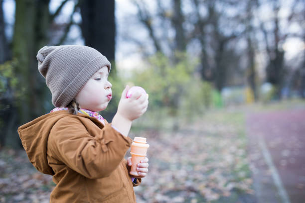 istock Preschool Age Girl Blows Bubbles 1188263251