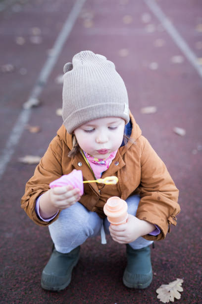 istock Preschool Age Girl Blows Bubbles 1188263277