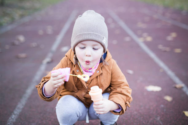 istock Preschool Age Girl Blows Bubbles 1188263287