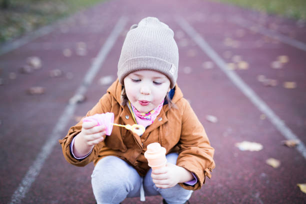 istock Preschool Age Girl Blows Bubbles 1188263356