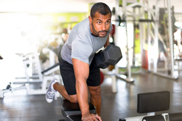 istock Strong handsome sport man making weightlifting in the gym 1188266559